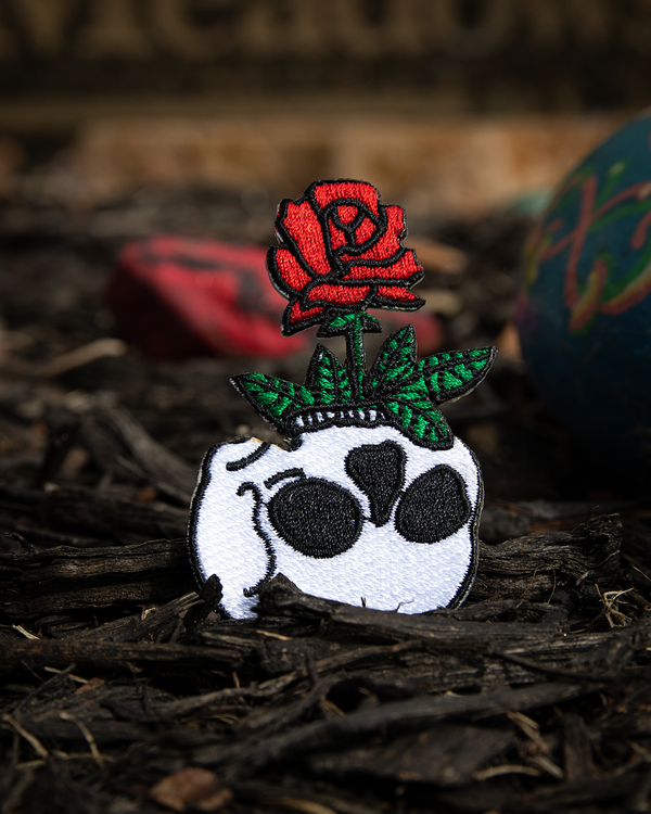 Patch with a skull and red rose on a dark background