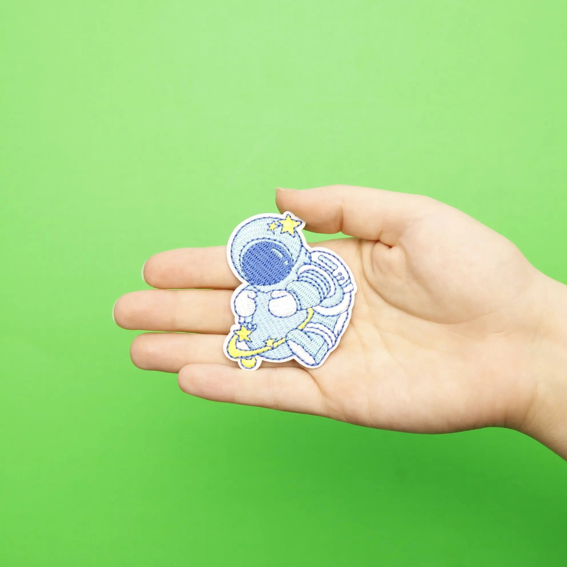 Small Blue Astronaut Hugging A Blue Planet With Rings Embroidered Iron On Patch