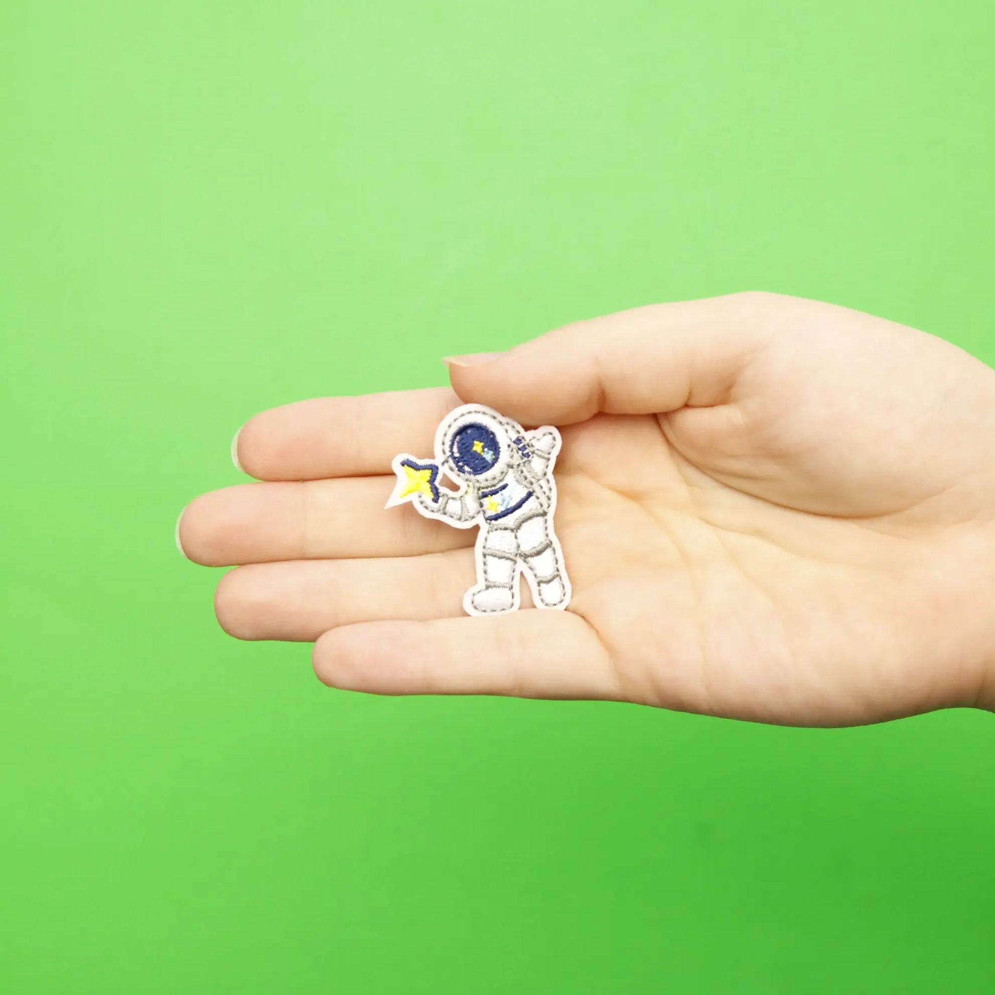 Small Grey Astronaut Holding A Star Embroidered Iron On Patch