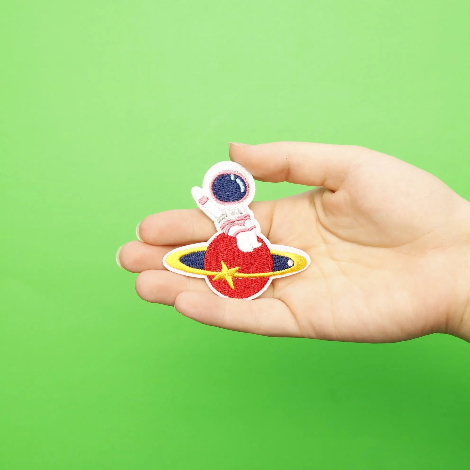 Small Pink Astronaut Sitting On A Red Planet Embroidered Iron On Patch