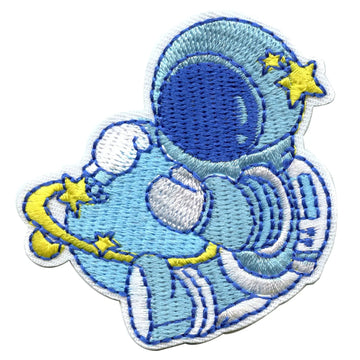 Small Blue Astronaut Hugging A Blue Planet With Rings Embroidered Iron On Patch